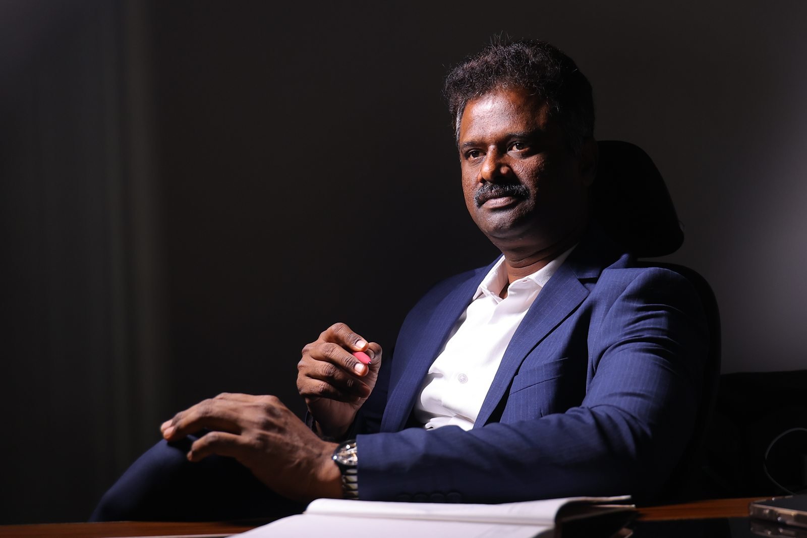 A. Amuthan, healthcare leader and staff trainer, at his desk